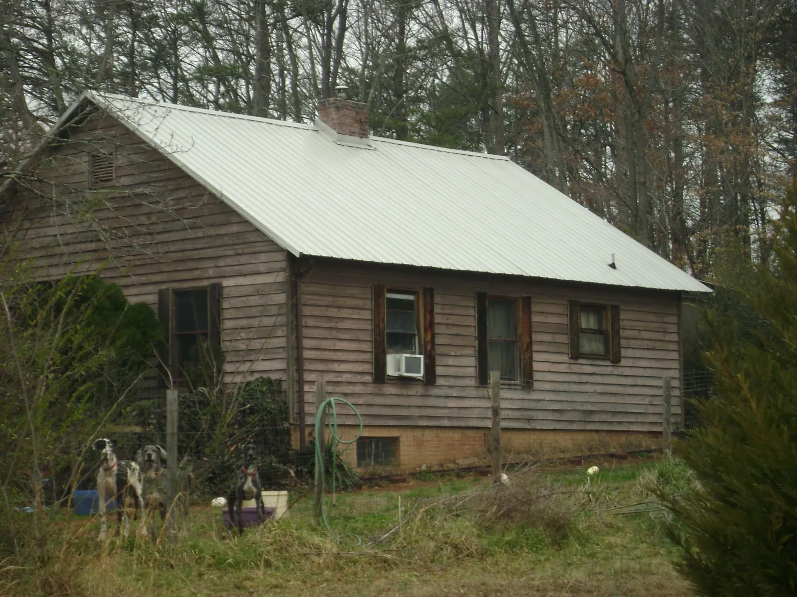 White metal roof on an old wood sided farmhouse, from a Metal Roof Installation job in Albertson